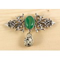 Брошь из агата зеленого (тонир.) "вензель", основа 70х2.4мм, овал 18х13мм, подвеска яшма далматиновая