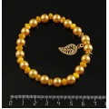 Браслет перламутр тонир. желтый (рондель), майорка (шарик 8мм), с подвеской