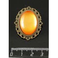 Брошь пластик оранжевый (эффект опала), с ажурным контуром, цвет бронза, овал 25х18мм