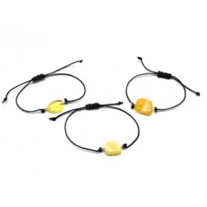 Руна Отал на браслете с янтарем 10*17мм на шнурке цвет медово-молочный