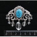 Брошь из бирюзы (иск.) "трюмо", овал 18х13мм, со стразами и подвесками из горного хрусталя