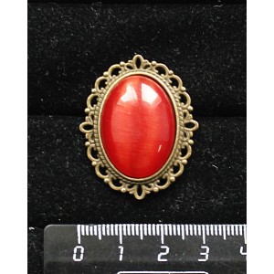 Брошь из кошачьего глаза (синт.),  цвет тёмно-оранжевый, овал 25х18мм, оправа с узором цвет бронза